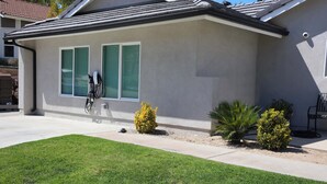 A single-story house with a grey roof, green shutters, and a small front yard with two bushes. - Charming 1-bedroom house with WiFi, AC in peaceful Santa Clarita Brand New (Santa Clarita)