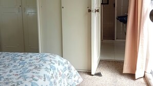 A bedroom with a bed, a wardrobe, and a bathroom visible through an open door. - Suite with moons of the Amazon River, by Reforma 222 (Ciudad de México)