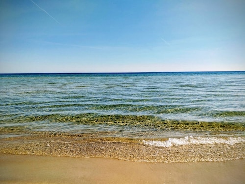 Cozy house with large wooden deck near the sea and the beach