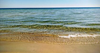 Cozy house with large wooden deck near the sea and the beach