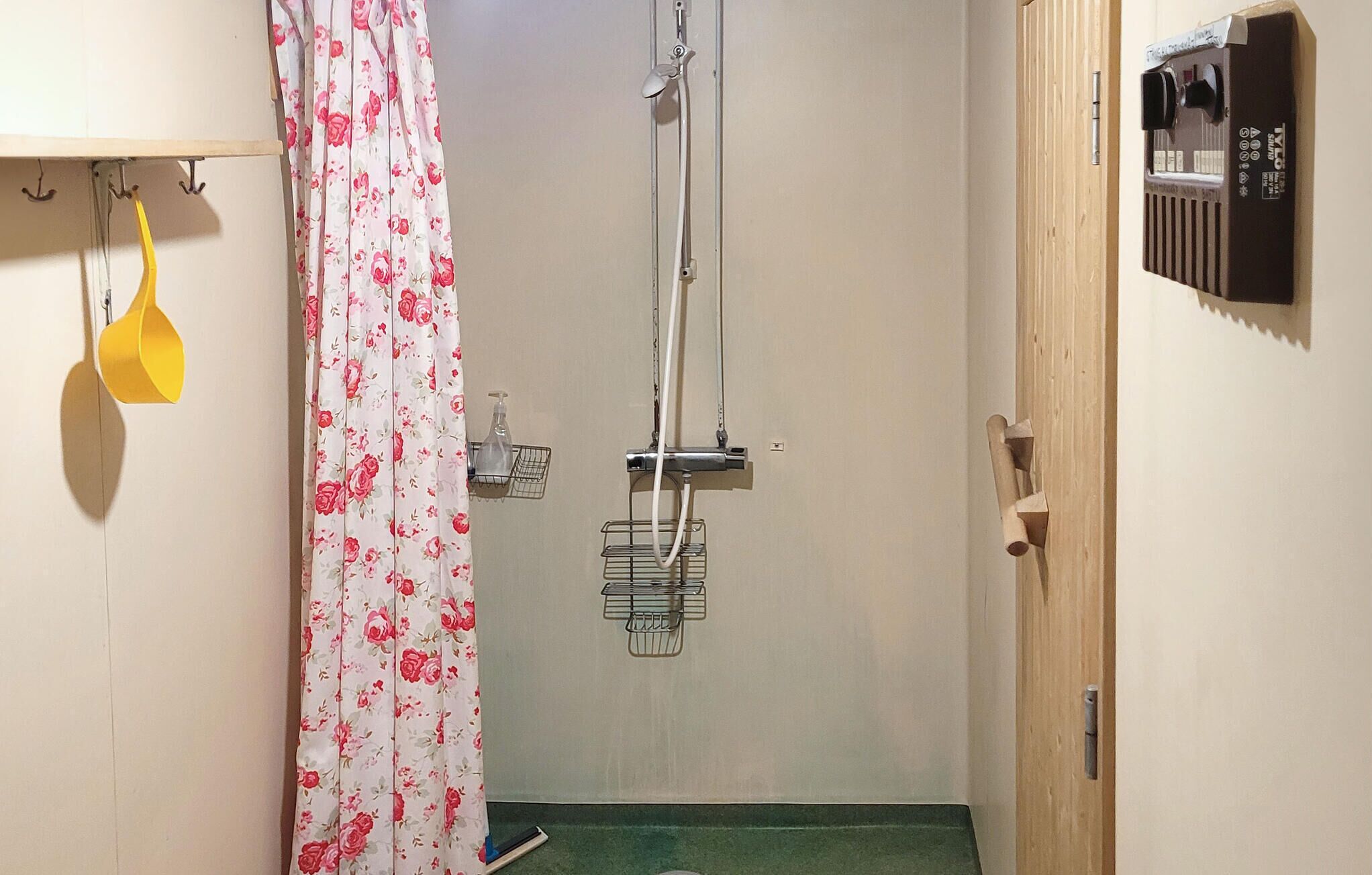 A bathroom with a shower, a toilet, and a sink.