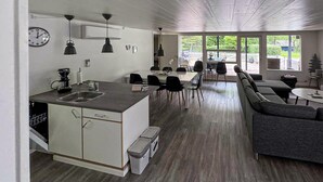 A modern kitchen with a central island, dining area with chairs, and a sofa. - 3 bedroom pet friendly home in Toftlund (Toftlund)