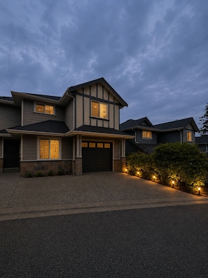 A two-story house with a dark roof, a garage, and a driveway. - Beautiful Place to Stay (Victoria)