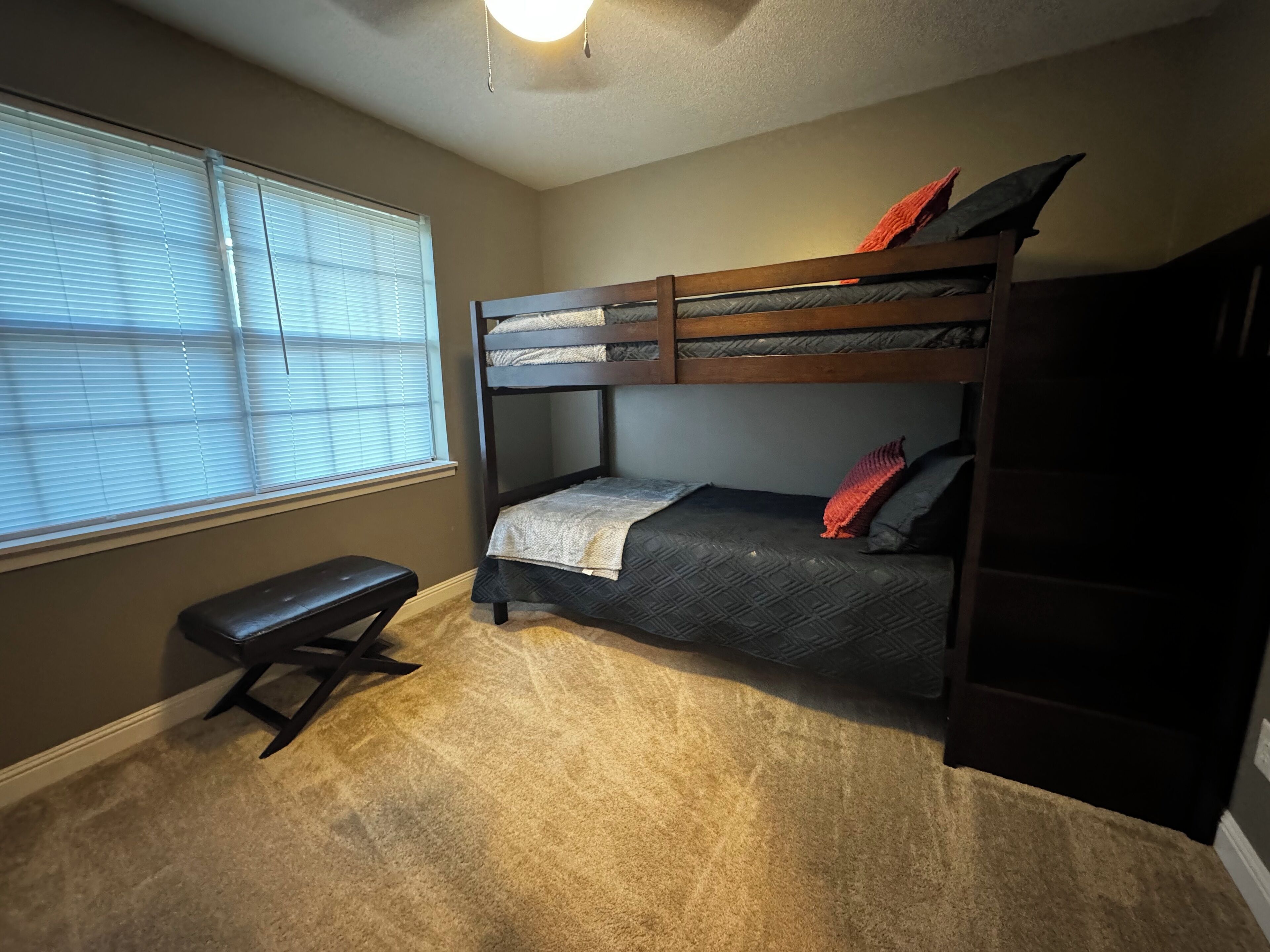 twin bunk beds closet and smart tv.