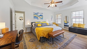 A bedroom with a bed, bedside tables, a desk, a chair, a bench, a ceiling fan, and a window. - Quiet & safe cul-de-sac. Bike, kid, dog, & work friendly. Ping-pong & foosball ! (Bentonville)