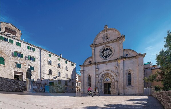 A historic building with a prominent clock tower and arched windows.