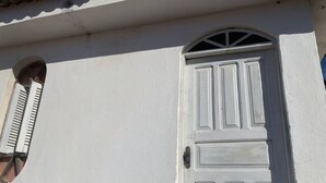 A white door with a small window above it. - Studio (unfurnished) Monthly (Neópolis Natal)