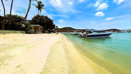 On the beach, white sand, sun loungers, beach massages. Rockstar Beach Apartments