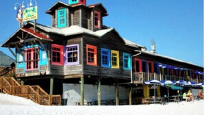 A wooden building with colorful windows and a sign that reads "Motel." - ~VIP by the Beach~ Chair Service Included (Destin)