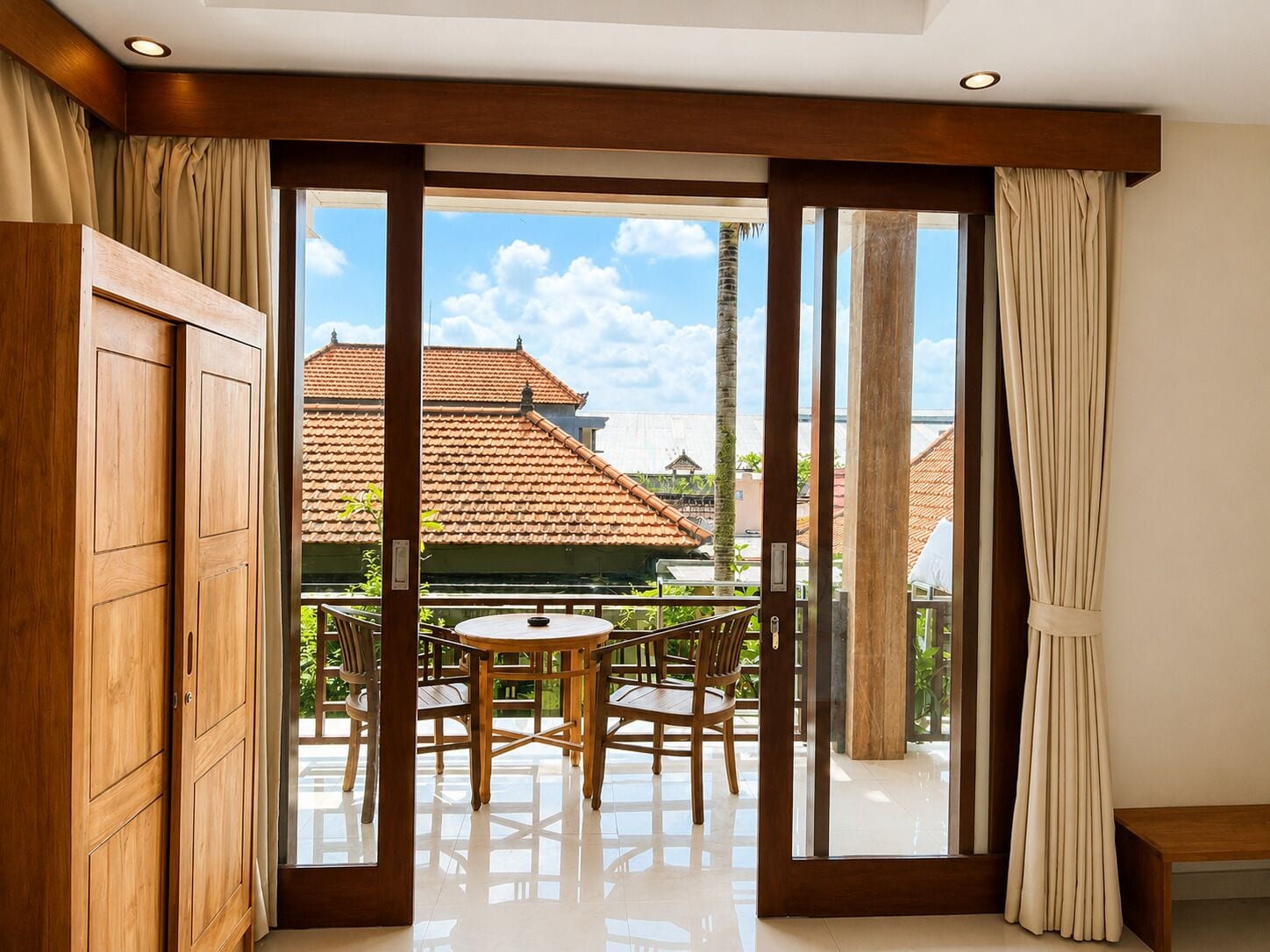 A room with a sliding glass door leading to an outdoor patio with a table and chairs.