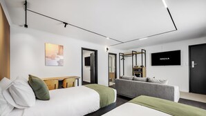 A modern hotel room with a bed, a sofa, a TV, and a desk. - Innova Motel Warrnambool (Warrnambool)