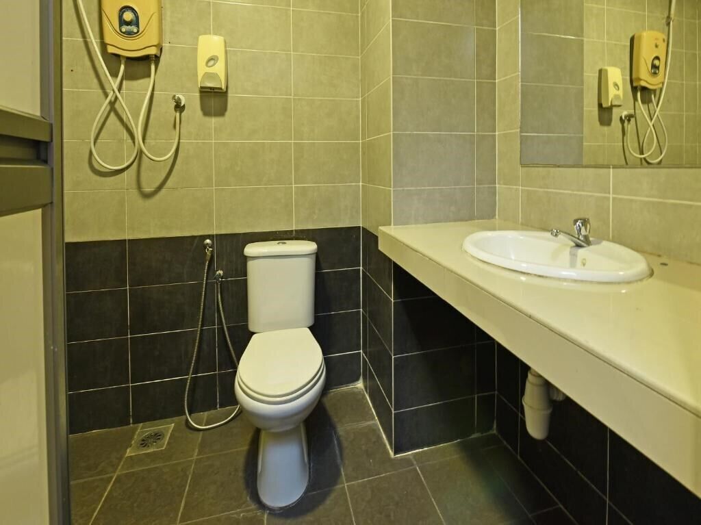 A bathroom with a toilet, a sink, and a shower.