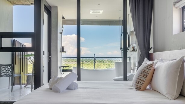 A modern bedroom with a large bed, a view of the outdoors, and a balcony. - Ningxialight (Wujie)