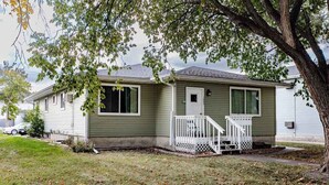 A single-story house with a front porch and a small front yard.