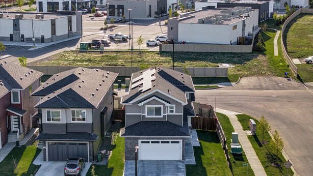 A residential area with modern houses, a driveway, and a parking lot. - St. Albert Luxury New 2BR/2BA Basement • Private Entrance • Pet-Friendly (St. Albert)
