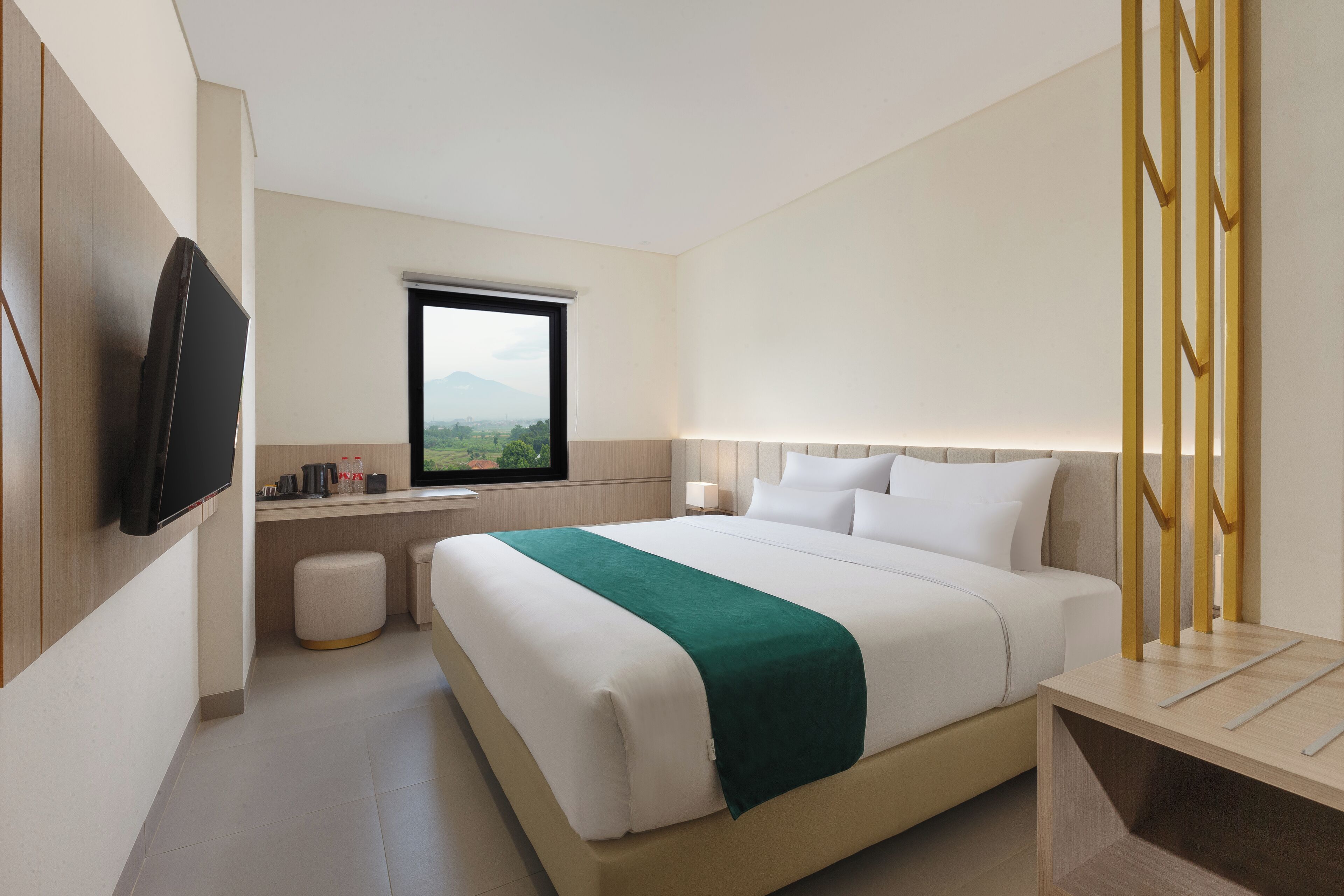 A modern hotel room with a bed, a TV mounted on the wall, a window with a view, and a bedside table.