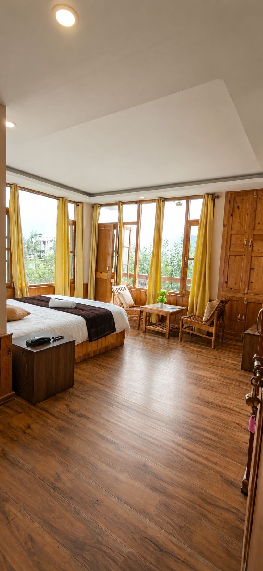 A room with a bed, a desk, a chair, and a table.