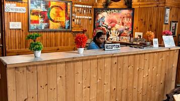 A reception desk with a wooden finish, a clock, and a 'Reception' sign.