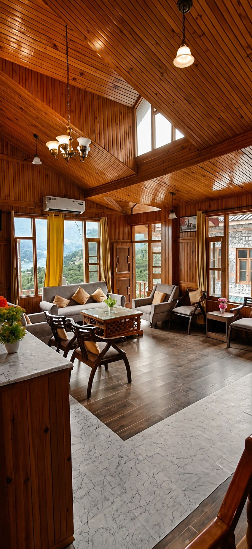 Une pièce spacieuse aux murs et au plafond en bois, un coin repas avec une table en marbre et de grandes fenêtres offrant une vue sur l’extérieur.