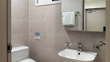 Shower, hair dryer, slippers, towels