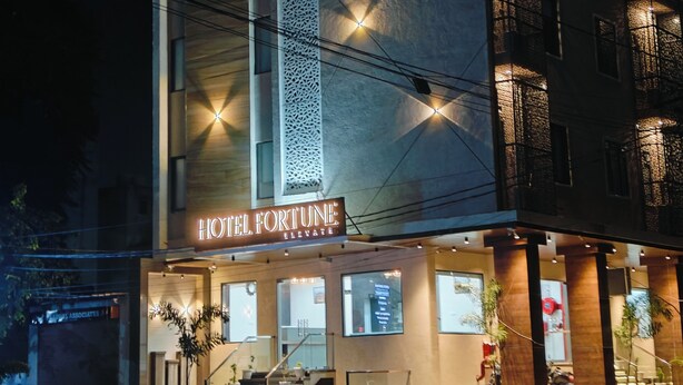 A modern hotel with a prominent sign reading "HOTEL FORTUNE ELEVATE". It features a vertical design with a patterned facade and multiple windows. - Hotel Fortune Elevate (Jaipur)