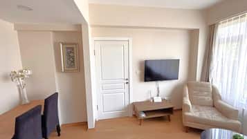 Family Suite, Partial Sea View | Living area | 40-inch LED TV with satellite channels