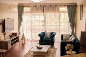 Luxury Apartment, Hill View | Living area | TV - Sand Grains Residences 007 (Entebbe)
