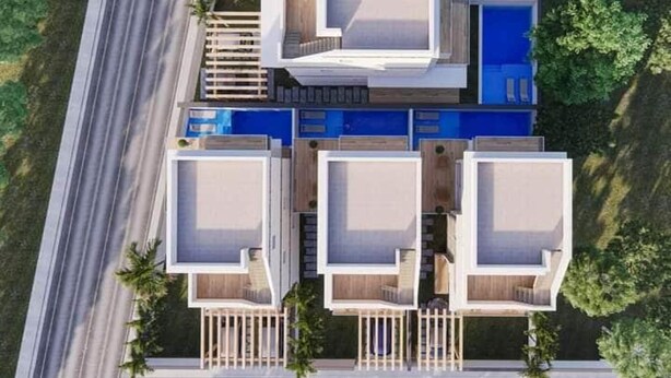 A modern multi-story building with a central courtyard, balconies, and a swimming pool.