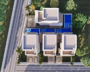 A modern multi-story building with a central courtyard, balconies, and a swimming pool. - Villa Caraibica Piscina Privata (Sosúa)