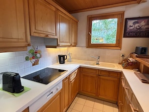 Kitchen features a dishwasher, sink, and window above.