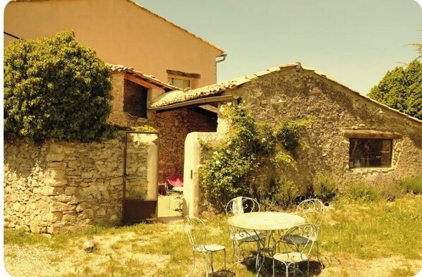Enjoy outdoor dining or relaxation in this charming country home's peaceful surroundings.