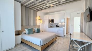 A modern bedroom with a bed, bedside tables, and a built-in wardrobe.