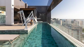 Indoor pool, open 9:00 AM to 9:00 PM, pool umbrellas, pool loungers