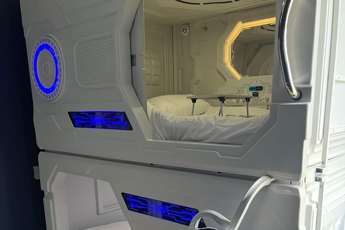 A bunk bed with a control panel and a bed inside.
