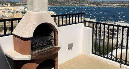 This penthouse is located in the lovely touristic beach village of Mellieha, only a few minutes walk away from Malta's longest sandy beach. It is walking distance from many restaurants and other amenities you may need.