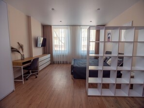 A modern bedroom with a desk, a bed, and a TV. - Contactless check-in, functional area of ​​the apartment, workplace (Lviv)