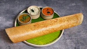 A dosa with three chutneys on a banana leaf. - Seasons Stay (Vijayawada)