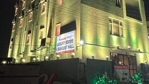 A multi-story hotel with illuminated signage advertising 'Seasons Stay Luxury Rooms & Banquet Hall'. - Seasons Stay (Vijayawada)