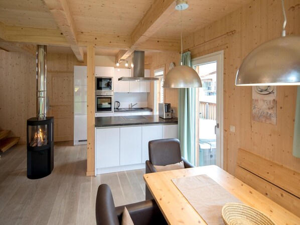 Enjoy cooking in this well-equipped kitchen with a central island, wood-burning stove, and dining area.