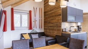 A modern kitchen with grey cabinets, a wooden countertop, and a built-in microwave. - Inviting Chalet on the Ski-slope (Stadl-Predlitz)