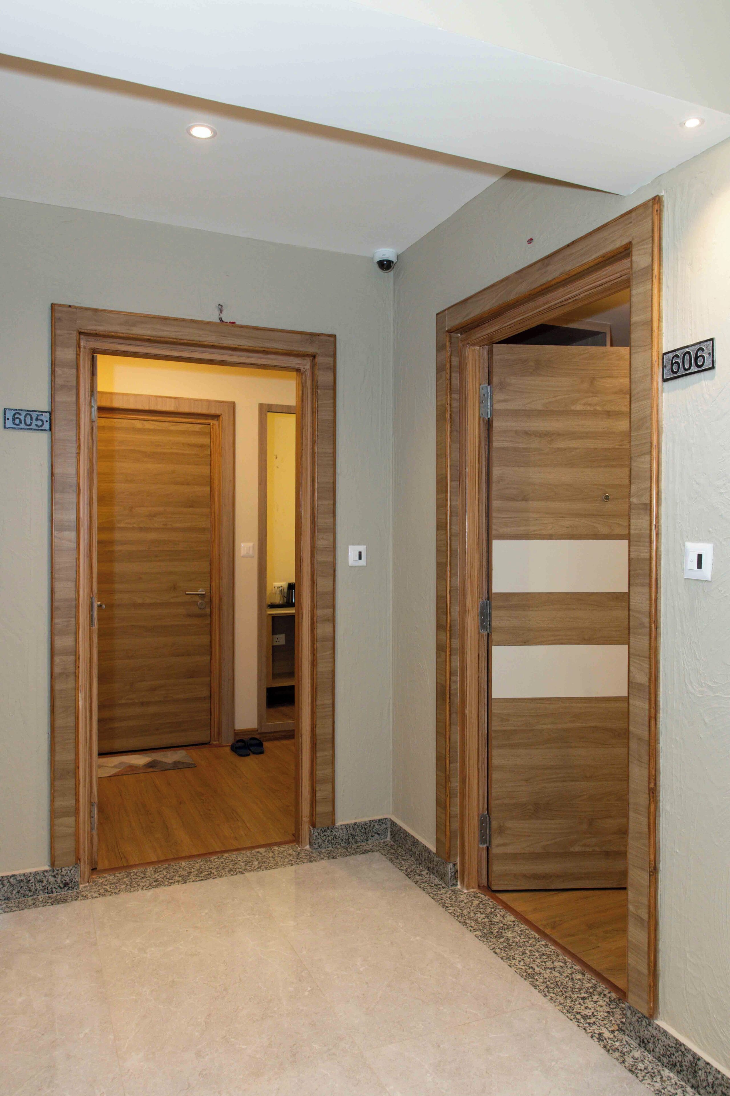 A hallway with two wooden doors, one labeled '605' and the other '606'.