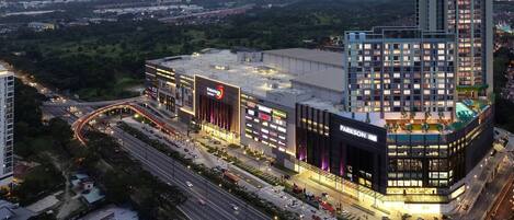 A modern commercial building with multiple floors, large windows, and a prominent sign for 'Parkson'.
