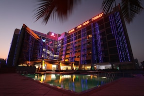 A hotel with a pool and illuminated exterior. - Hotel The Cox Today (Cox's Bazar)