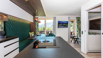 Deluxe Suite, Balcony, Mountain View | Living area | TV