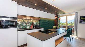 Deluxe Suite, Balcony, Mountain View | Living area | TV