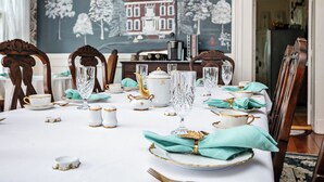 A dining table set with white and gold china, crystal glasses, and teal napkins. - 7 Private Rooms, Country Setting Bourbon Trail, patio/firepit. Breakfast inc. (Springfield)