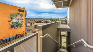 A high-rise building with a view of a sports bar and a parking lot below. - Tracyton Condo 202 in Bremerton (Bremerton)