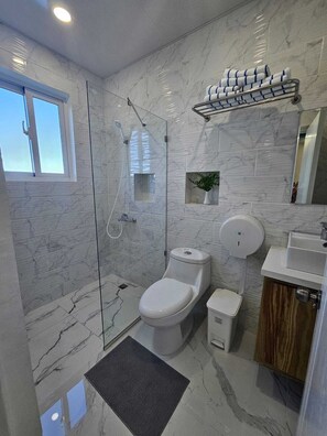 Family Twin Room, Balcony, Partial Sea View | Bathroom | Shower, towels, soap, toilet paper - Hotel Gutz (Puerto Plata)