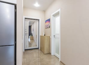 Corridors lead to rooms and kitchenettes, offering a functional and clean design.