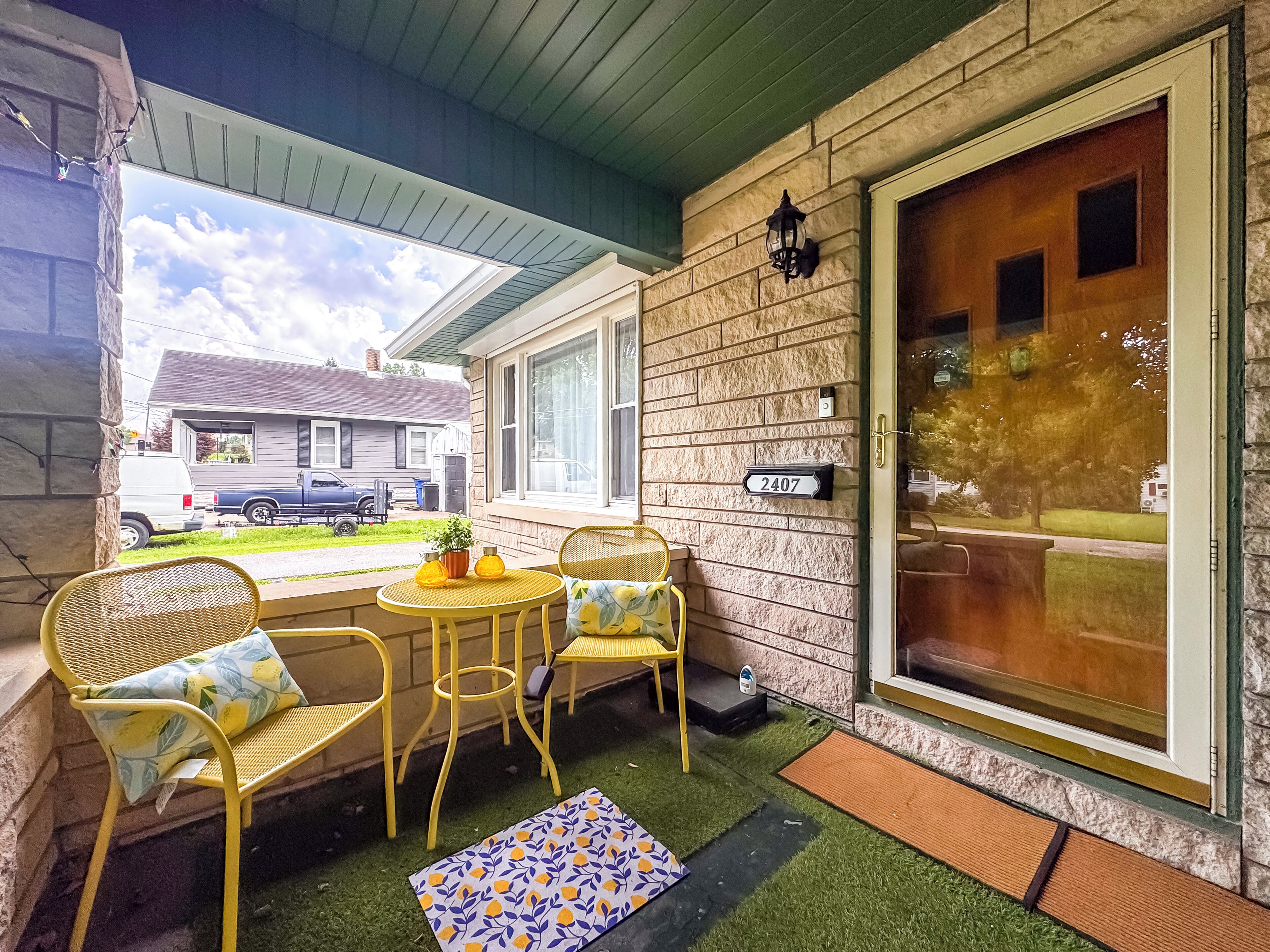Charming covered front porch with sunny seating for morning coffee